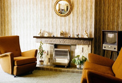 Living room with television, electric fireplace and armchairs, England, photographed in 1962