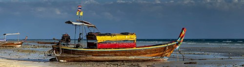Longtail boat on the beach, at low tide, Koh Ngai Island, Andaman Sea, Satun Province, Southern