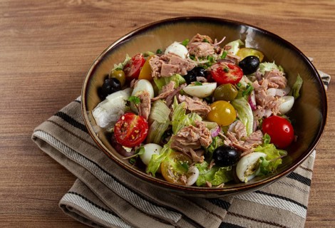 Salad with canned tuna, vegetable salad with quail eggs, lettuce, red onion, cherry tomatoes,