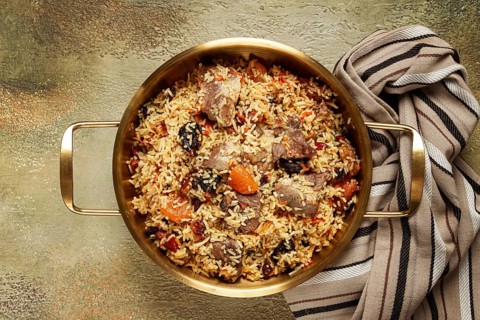 Rice dish with meat and dried fruits, in a large pot, pilaf, homemade, no people