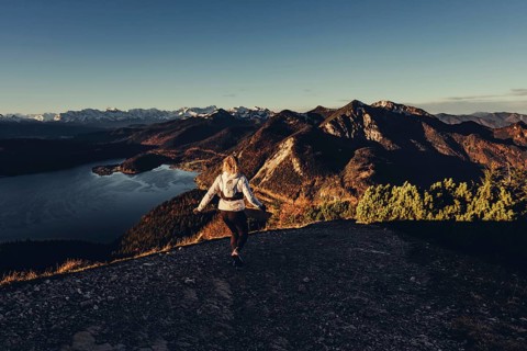 Trail running in autumn on the Jochberg on Lake Walchensee against the wonderful backdrop of the