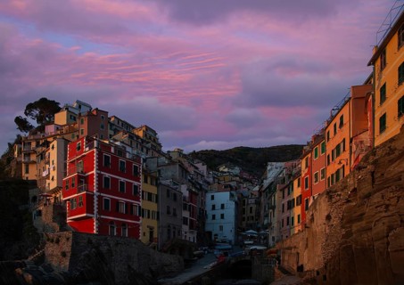 Italy, Riomaggiore colorful buildings overlooking scenic shoreline. Cinque Terre landscapes in