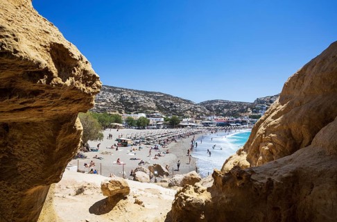 View from the rock caves to the beach of Matala, south coast, Crete, Greece, Europe