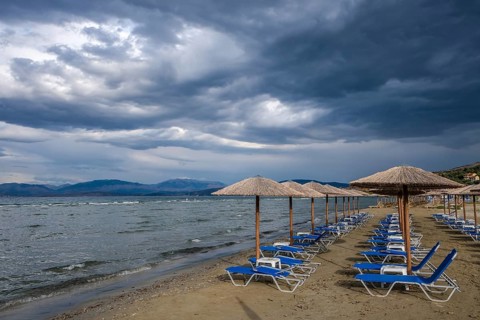 Kalamaki, Corfu, Greece, Sun loungers and parasols on Kalamaki beach in the north-east of the Greek