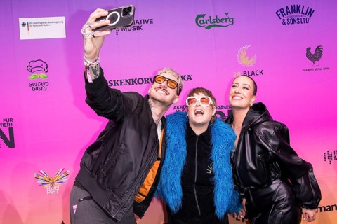 Guests take selfies on the red carpet in front of the Polyton 2024 award ceremony in Berlin's