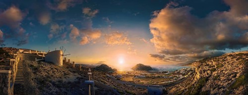 Picturesque sunset over a Mediterranean coastal landscape of Arkasa with windmill and sea view,