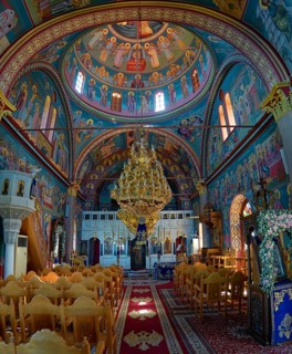 Interior of the church of Panagia Vrisiani with church dome, frescoes and magnificent chandelier in