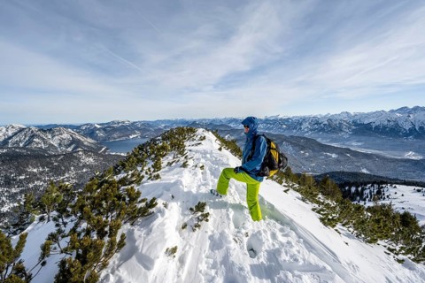 Ski tourer at the summit of Simetsberg, mountain panorama, Estergebirge, Bavarian Prealps, Bavaria
