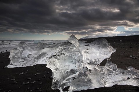 Little icebergs and crushed ice on the black beach at Joekulsarlon glacial lake