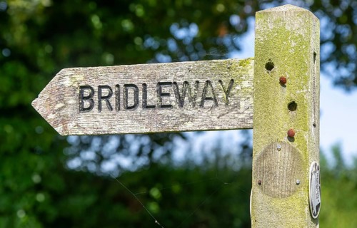 Close up wooden bridleway sign direction arrow pointer, Sutton, Suffolk, England, UK