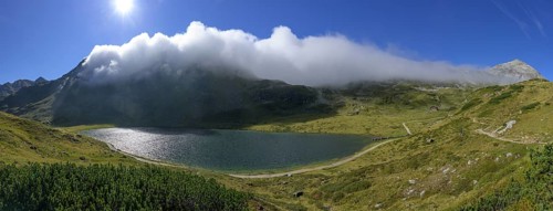 Panorama upper Giglachsee with fog over the mountain ridge on the right Styrian Kalkspitze,