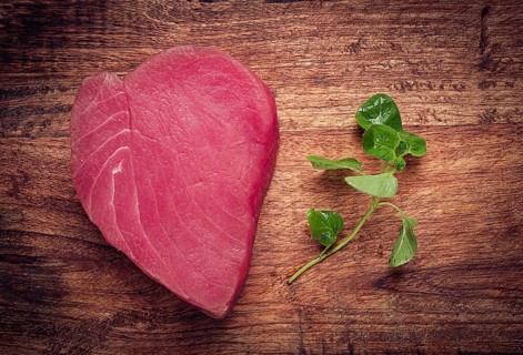 Fresh red tuna fillet, for steak, raw, top view, on a cutting board, no people
