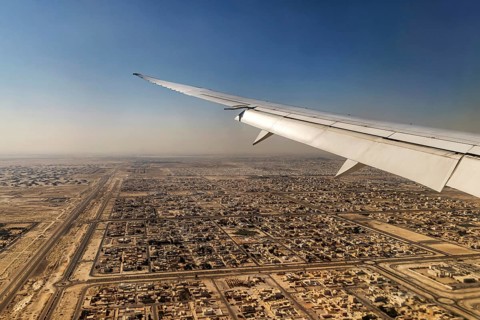 Landing approach over the desert to Abu Dhabi with the airline Etihad. View from the window of a