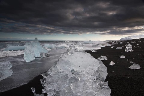Little icebergs and crushed ice on the black beach at Joekulsarlon glacial lake