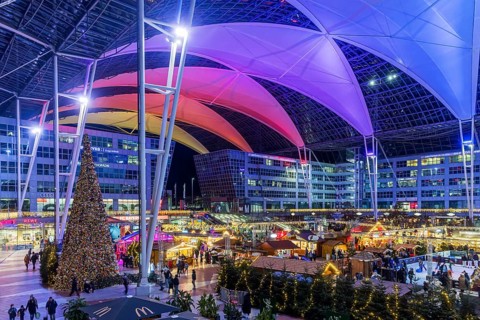 Christmas market at the airport in the evening, market stalls decorated for Christmas in front of