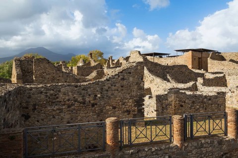 Remnants of old terracotta brick columns and residential building wall structures made of stones at