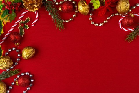 Christmas decoration frame with gold and red elements on a red background, copy room