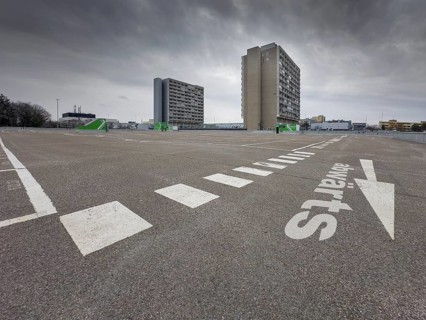 Symbolic image economic crisis, dark clouds in the sky, empty parking deck at