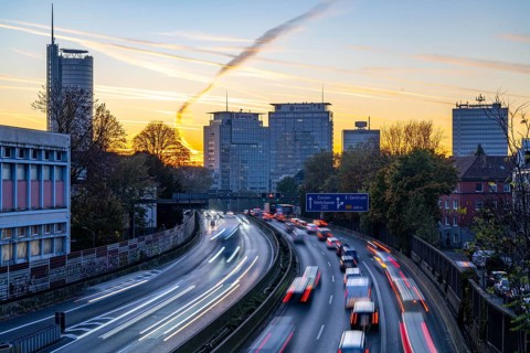 Evening traffic, partly with traffic jams, slow-moving traffic on the A40 motorway, skyline of