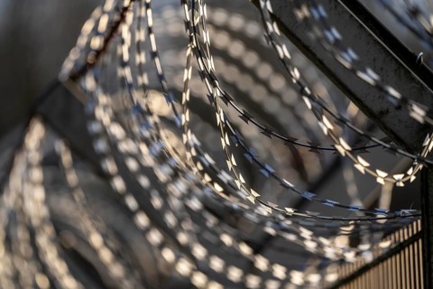 Symbolic image security, S-wire rolls, NATO wire, on a fence top, demarcation of a property,