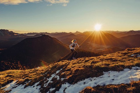 Trail running in autumn on the Jochberg on Lake Walchensee against the wonderful backdrop of the