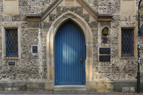 Entrance, blue wooden door, lodge sign, writing, letters, information board at the Marchtaler Hof,