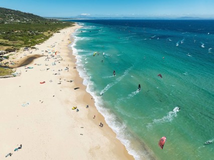 Kite surfers at the Valdevaqueros beach near Tarifa. In the distance the coastline of Morocco.