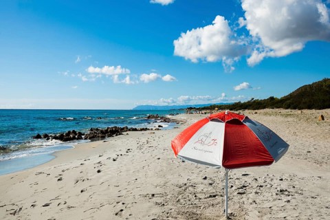Lonely beach and parasol, Spiaggia di Biderosa, Riserva Biderosa nature reserve, Orosei, Nuoro