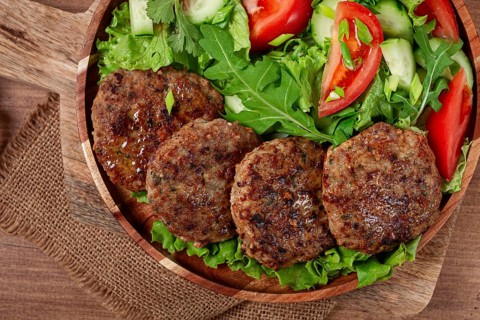 Fried cutlets, mixed minced meat, with vegetable salad, homemade, top view, no people