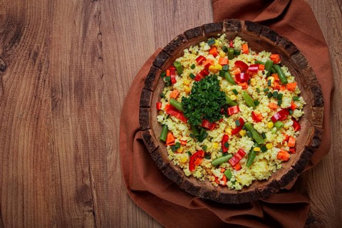 Couscous with vegetables, paprika, carrots, string beans, corn, homemade, top view, no people