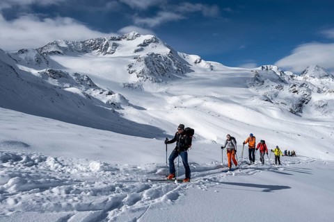 Ski tourers, behind the summit of Monte Cevedale, snow-covered mountain landscape, Ortler Alps,