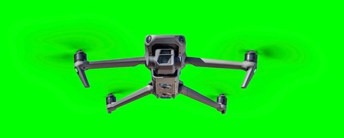 Isolated unmanned aircraft system (UAV) quadcopter drone in the air over A green screen