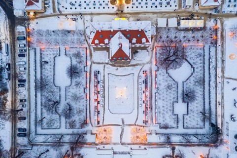 Aerial view of Wackerbarth Castle with castle park in snow and Christmas lights, Radebeul, Saxony,