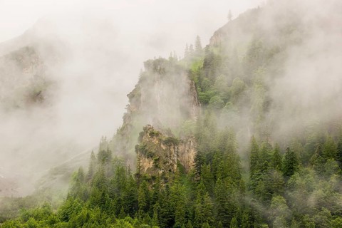 Wisps of mist cover the Karwendel mountains in the Großer Ahornboden nature reserve, Eng Valley,