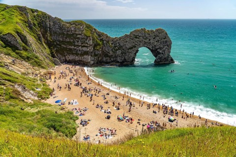 The natural rock bridge Durdle Door and beach of the UNESCO World Heritage Site Jurassic Coast,