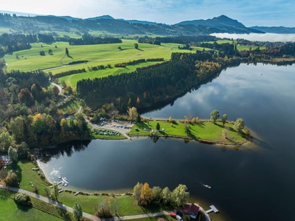 Sports facility and bathing area, lake Rottachsee, at village Petersthal, mt. Gruenten in the back,