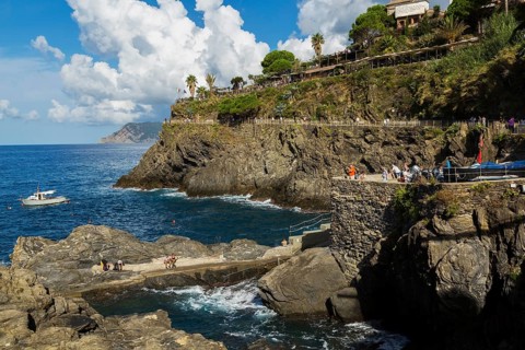 Tourists at belvedere overlooking the Ligurian Sea in Manarola village in late summer, Cinque