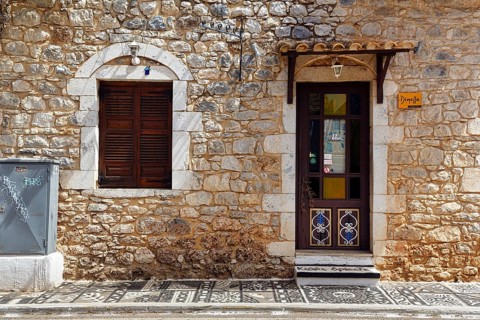 Façade with souvenir shop, typical stone house in Stoupa, former fishing village, Mani, Greece,