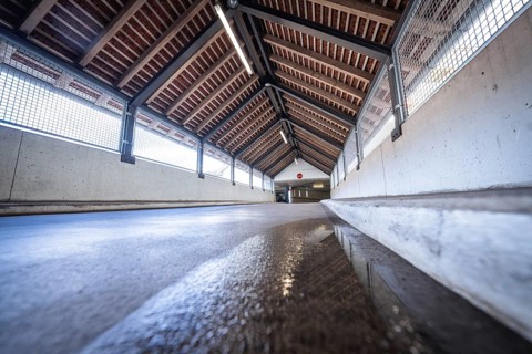 Perspective corridor with wooden beam ceiling and incidence of light, reflected on the floor, car