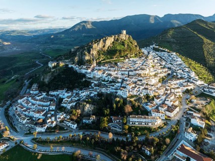 The White Town of Zahara de la Sierra below a Moorish castle. Aerial view. Drone shot. Cádiz