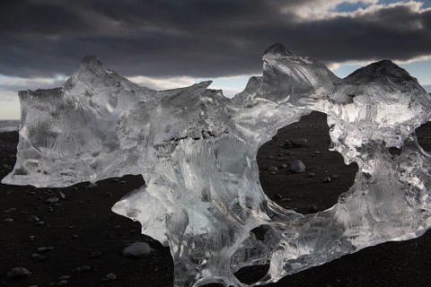 Little icebergs and crushed ice on the black beach at Joekulsarlon glacial lake