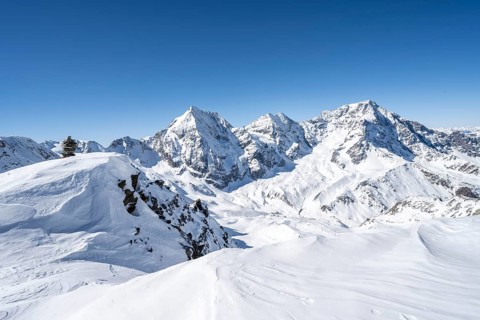 Mountain panorama with snow-covered mountain landscape in winter, view of mountain peaks