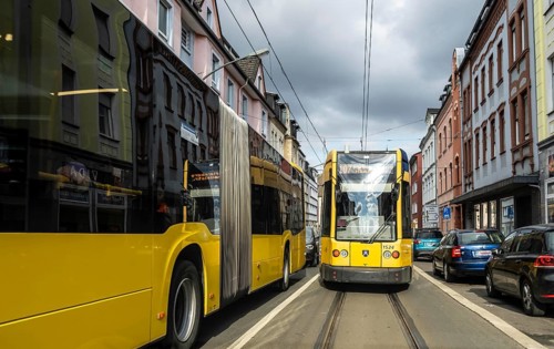 Tram and bus in traffic, on the street Schonnebeckhöfe in Essen-Katernberg, North Rhine-Westphalia,