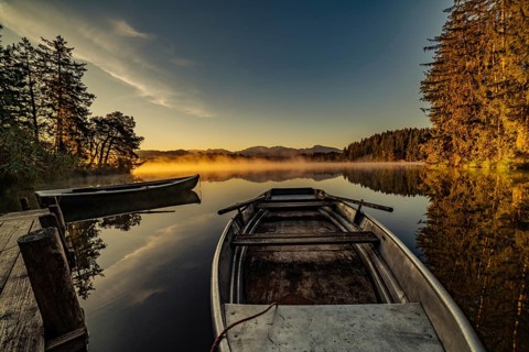 Boats in the autumnal Schmutter Weiher in the Allgäu near the municipalities of Halblech,