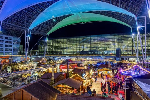 Christmas market at the airport in the evening, market stalls decorated for Christmas in front of