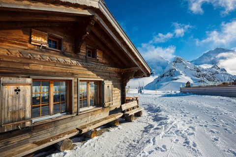 Wooden chalet and ski slope, with views of the Eiger, Mönch and Tschuggen, Grindelwald, Bernese