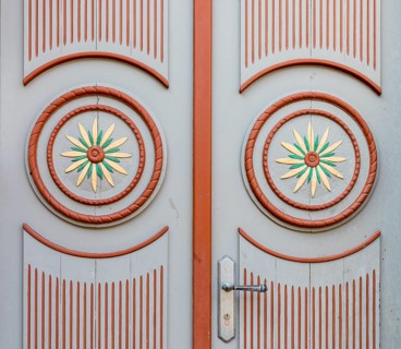Decorations on a front door with circles and flowers in red and white, Parchim,