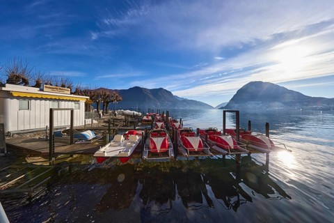 Pedal boat hire, pedal boats, lake, shore, ice cream parlour, mountains, haze, blue sky, cirrus