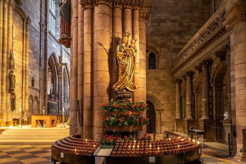 Madonna and sacrificial candles in the interior of Freiburg Minster, Freiburg im Breisgau, Black