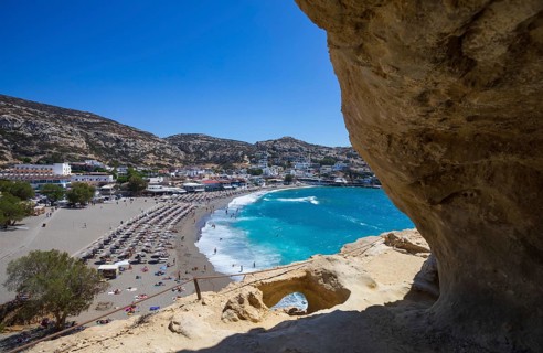 View from the rock caves to the beach of Matala, south coast, Crete, Greece, Europe